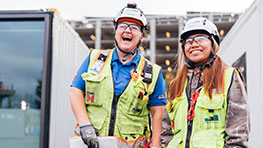 women in construction smiling on jobsite