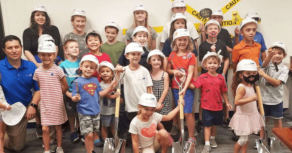 group of children wearing hard hats