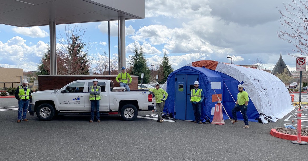 construction team with triage tent and Mortenson truck