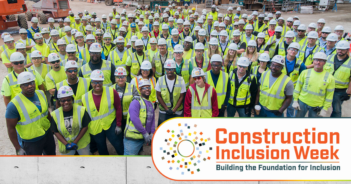 Large group of construction workers in hard hats and neon safety vests