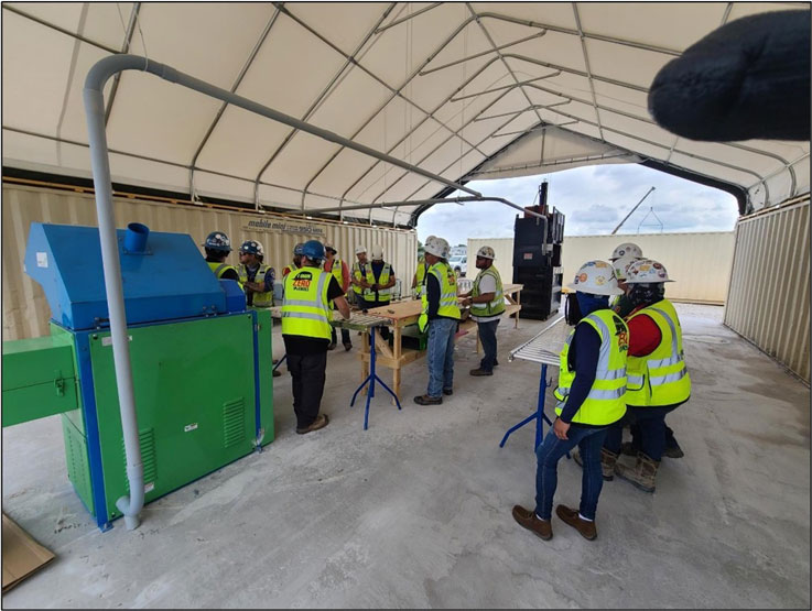 construction workers learning about waste managment on a construciton site