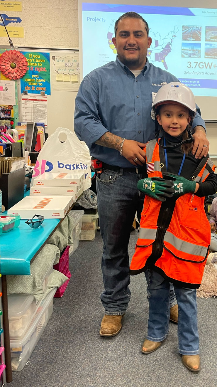 Construction worker with kid at school