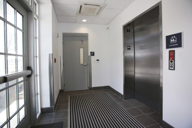 Hallway with door and elevator