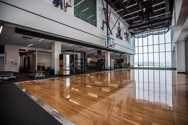 Gym with basketball hoop and big windows