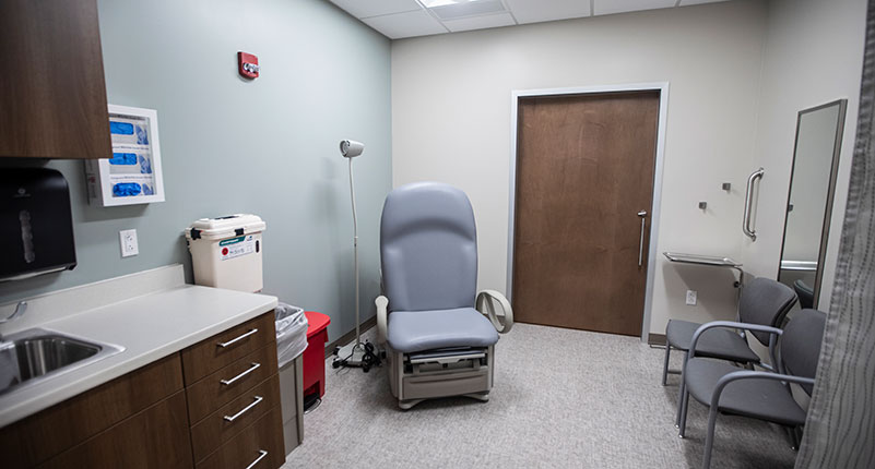Patient care room with sink and chairs