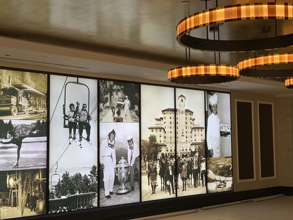 Wall with old photos on it and ceiling lights