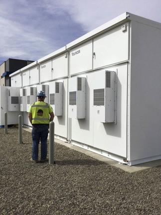 Construction worker standing by energy storage facility