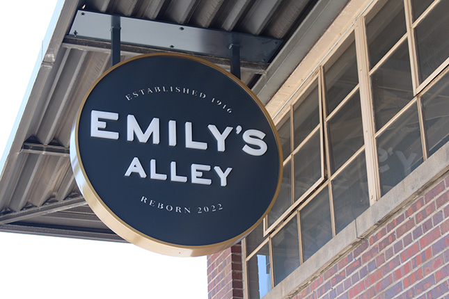 Emily Griffith Hotel - The Slate Denver, Tapestry Collection by Hilton Emily's Alley circular sign