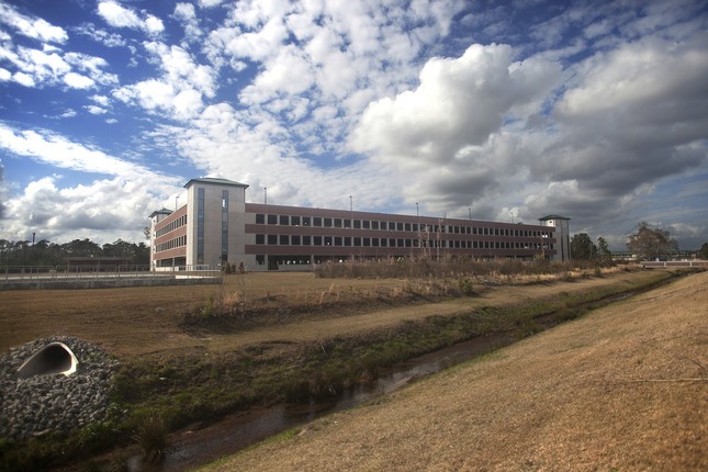 exterior of facility with drainage ditch and blue sky