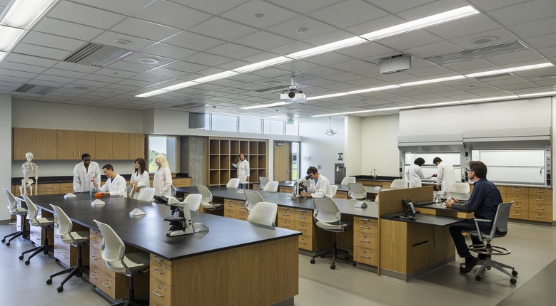 lab classroom with students in white lab coats