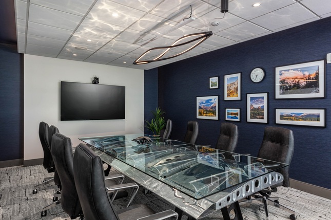 conference room with glass table and navy wall