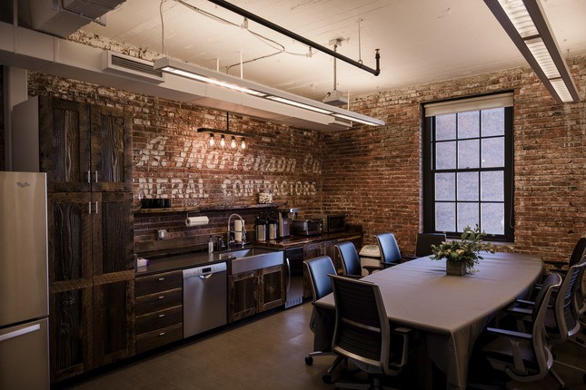 lunch, coffee area with brick wall in renovated office