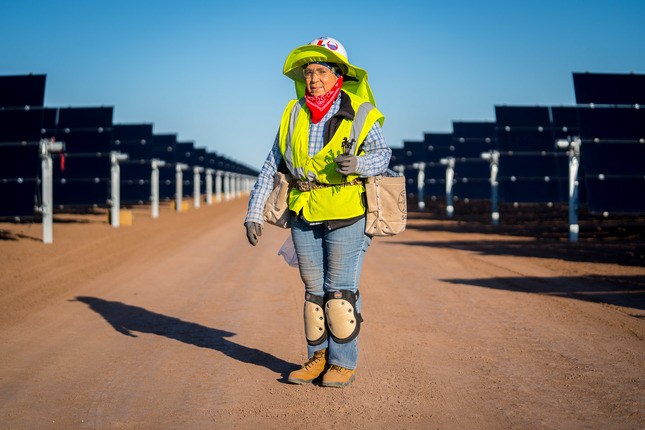 worker standing in newly constructed solar farm