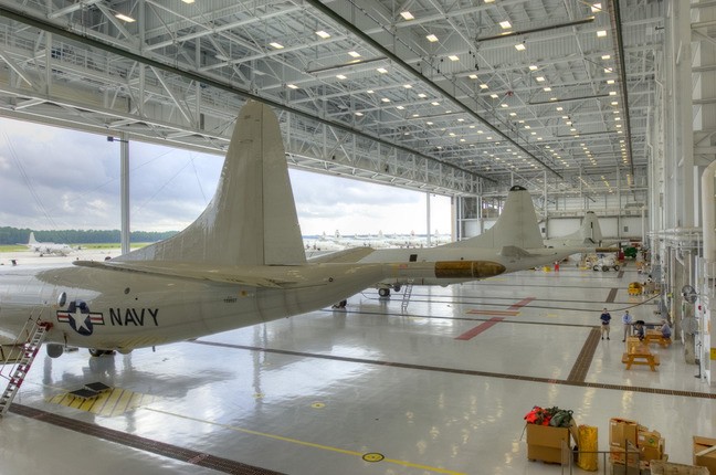brand new airport hangar with large Navy airplanes housed inside