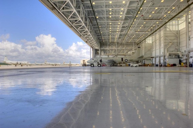 large new hangar with door open to blue sky