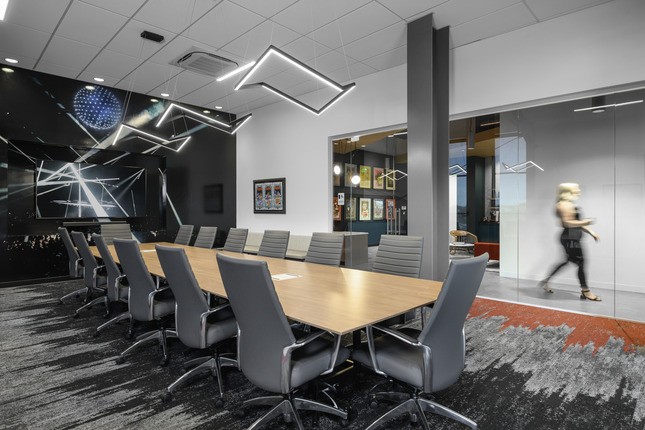 long conference table in room with modern lighting