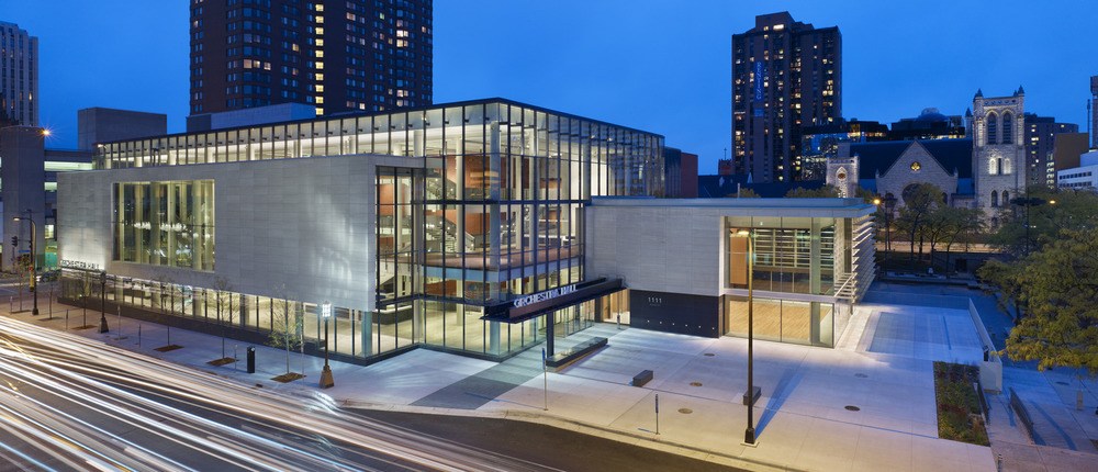 modern glass orchestra hall renovation lit up at night