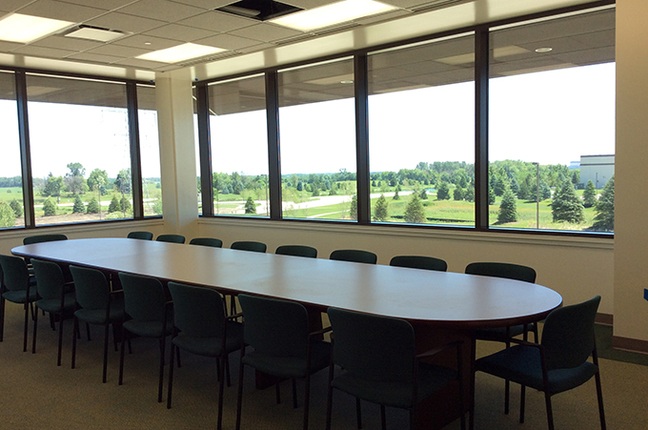 large meeting table in room with windows
