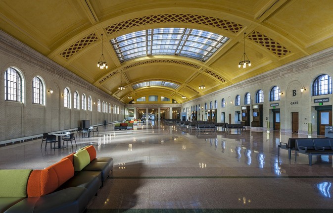 inside of a depot with yellow ceilings and large skylights
