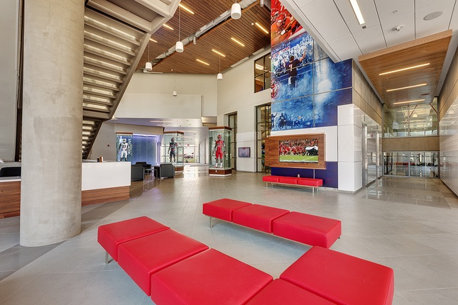 red benches in entry way of stadium