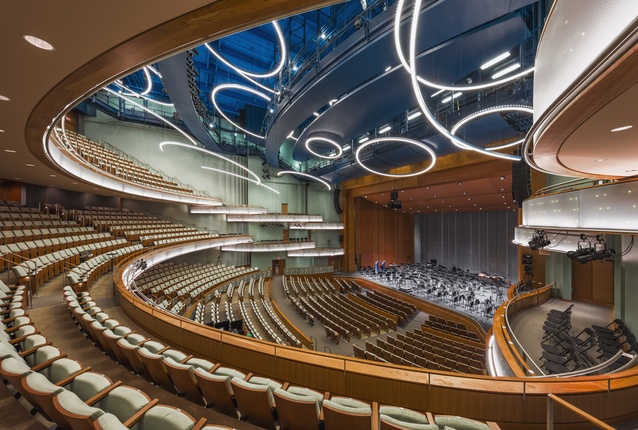 auditorium with stadium seating and large circular LED lighting