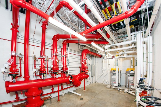 facility room with red pipes along wall