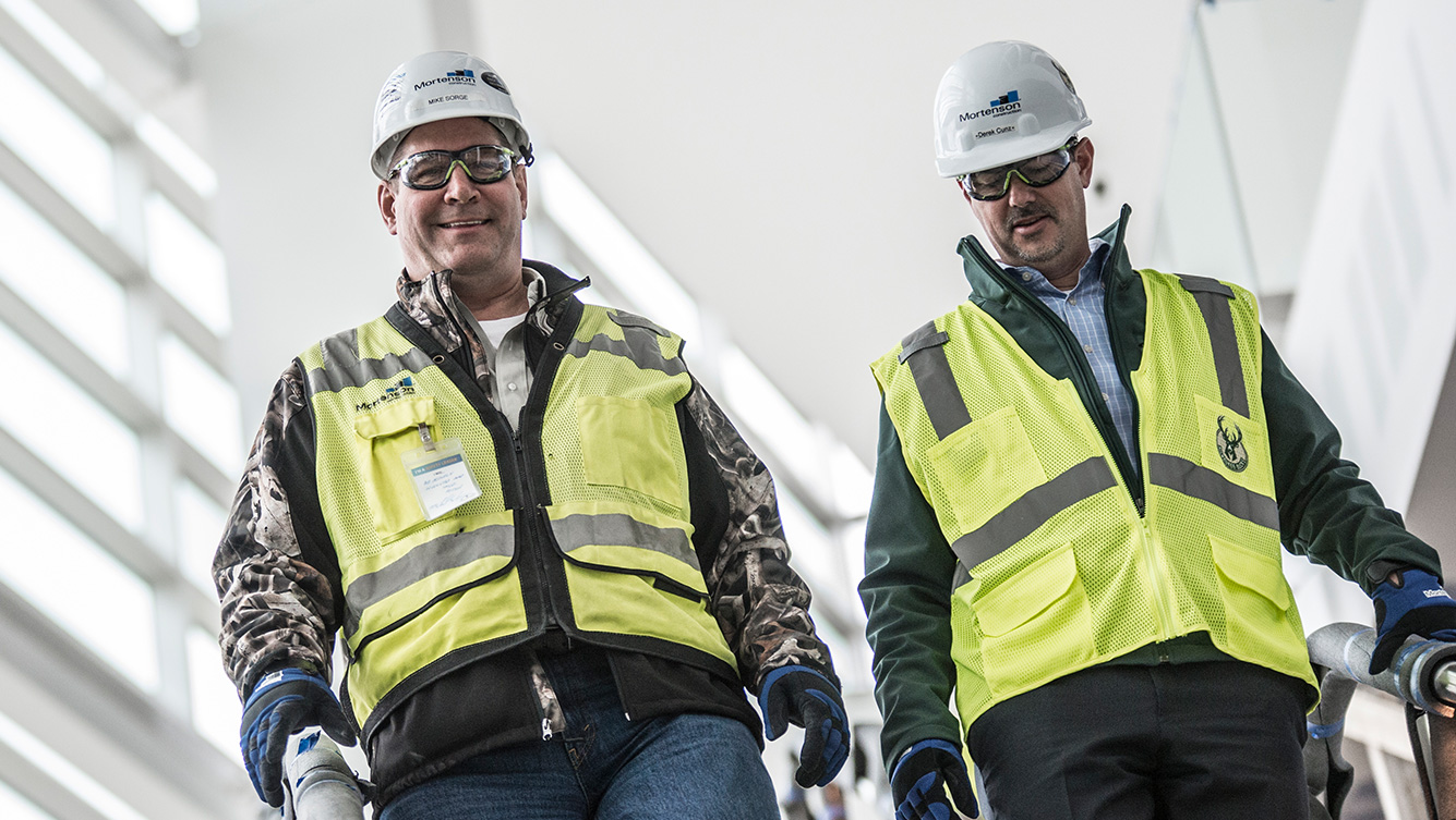 Derek Cunz and Mark Sherry walking construction job site