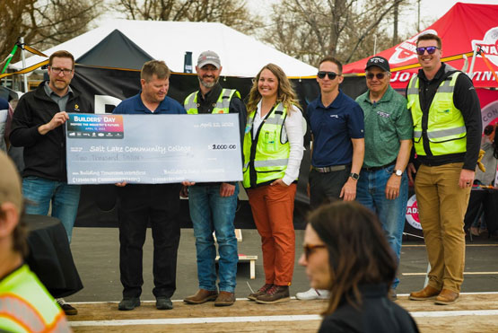 construction workers with big check at fundraiser