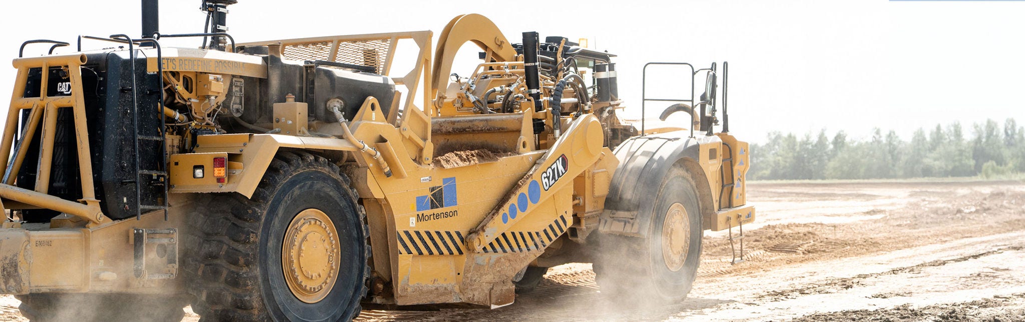 Heavy construction vehicle on dusty site