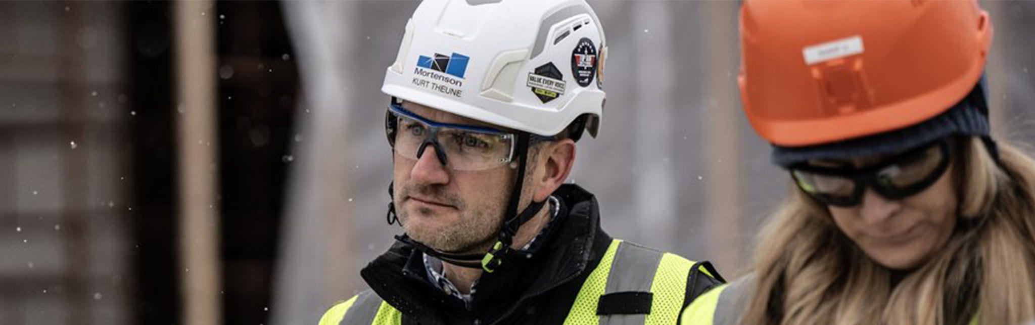 Construction workers wearing safety gear outdoors