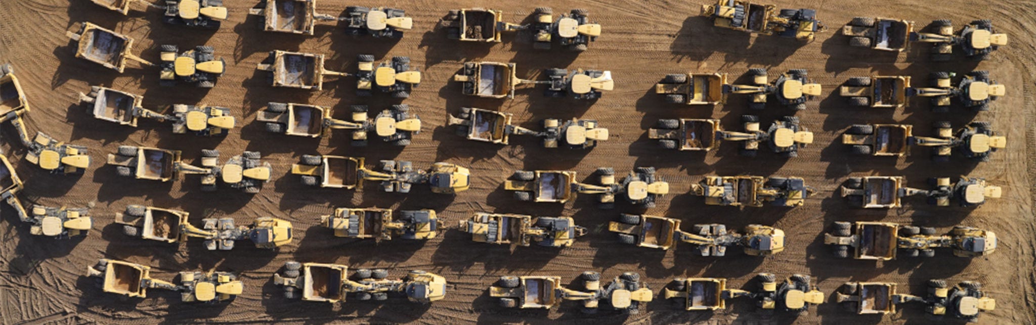 Aerial view of construction vehicles in rows