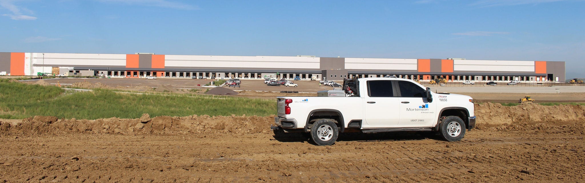 White pickup truck near construction site