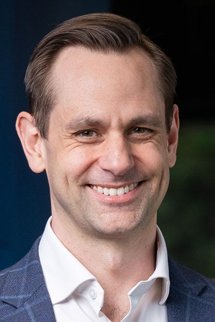 Professional man in blue blazer indoors