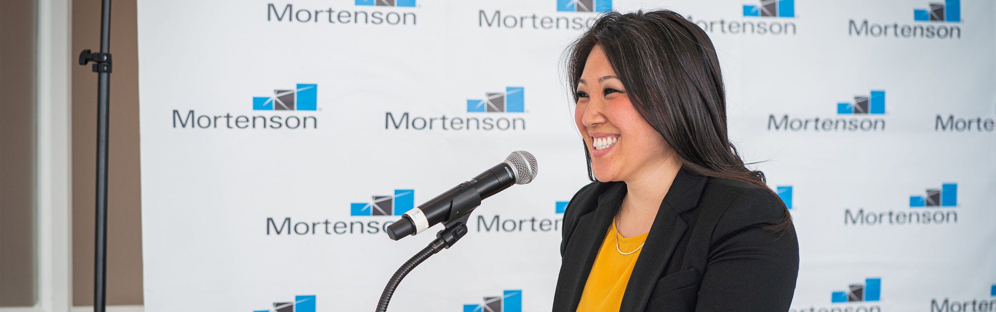 Speaker at Mortenson event with microphone