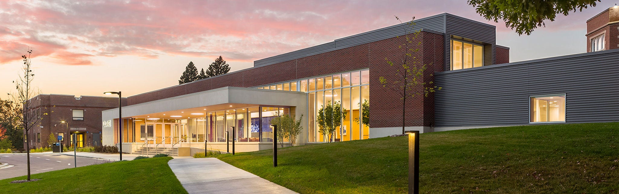 Modern building with glass facade at sunset