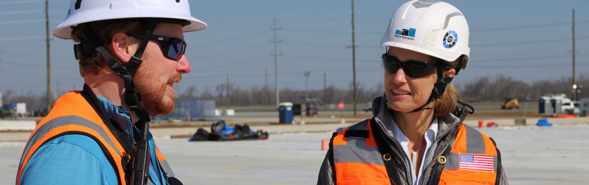 Smiling construction worker at active jobsite