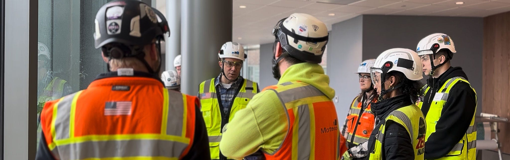 Construction crew meeting inside modern building